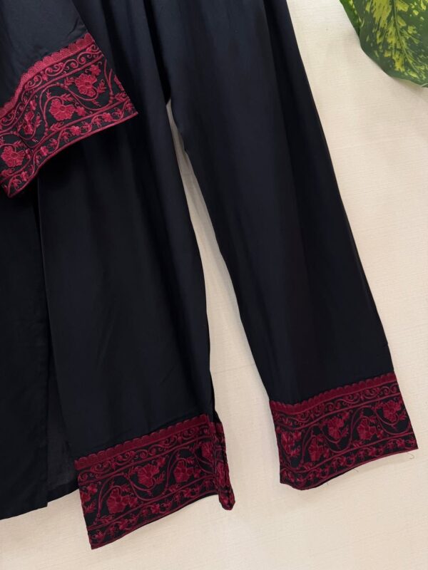 Woman wearing black kurta with red embroidery and matching printed dupatta, paired with black pants for women festive wear